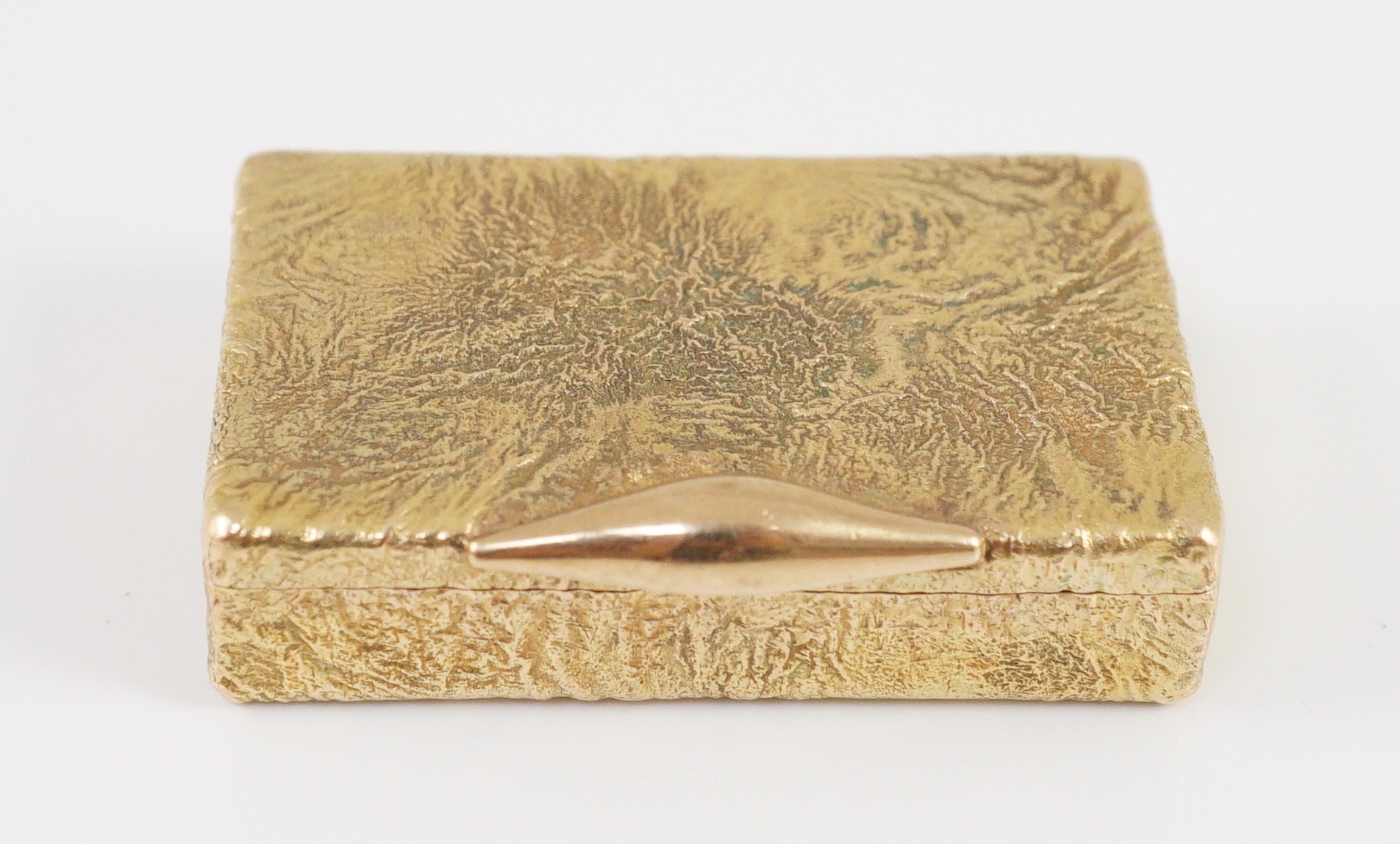 A 1960's 9ct gold Cartier rectangular pill box, with samorodok decoration